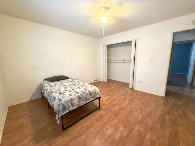 bedroom with hardwood / wood-style flooring and a closet