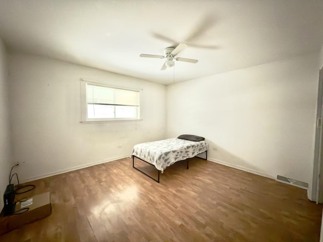 unfurnished bedroom featuring dark hardwood / wood-style flooring and ceiling fan