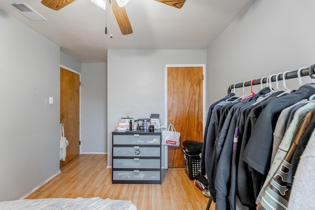 spacious closet featuring ceiling fan and light wood-type flooring