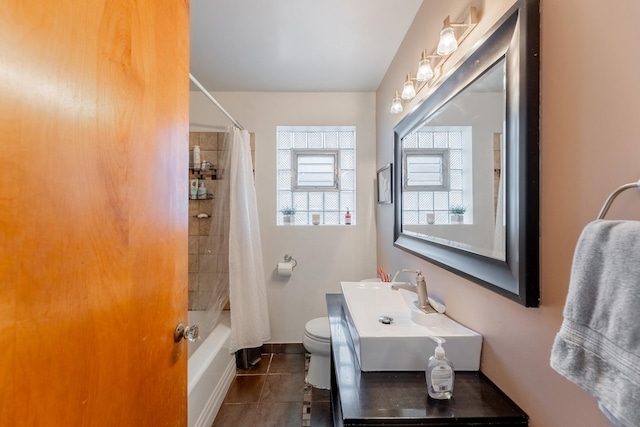 full bathroom featuring shower / bathtub combination with curtain, tile patterned flooring, vanity, and toilet