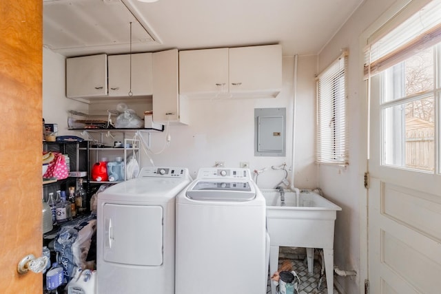 laundry area featuring cabinets, washing machine and dryer, electric panel, and a healthy amount of sunlight