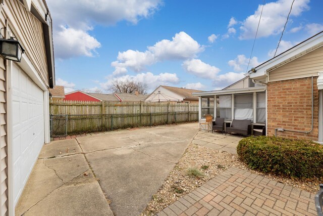 view of patio with a sunroom and a garage