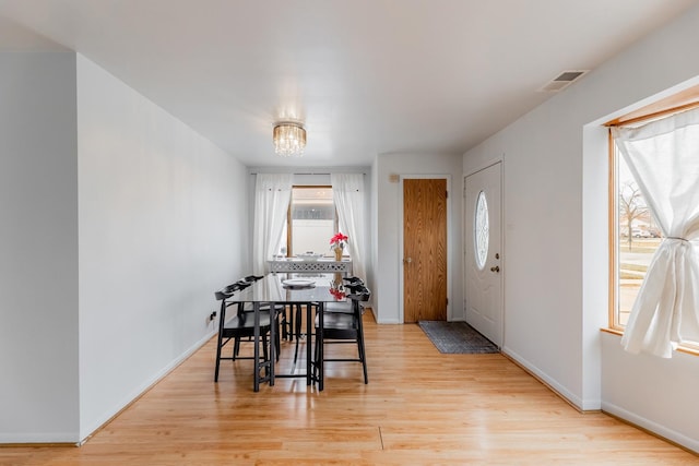 dining space featuring a chandelier and light hardwood / wood-style flooring