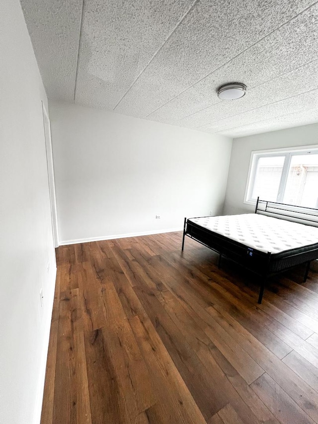 unfurnished bedroom featuring dark hardwood / wood-style flooring