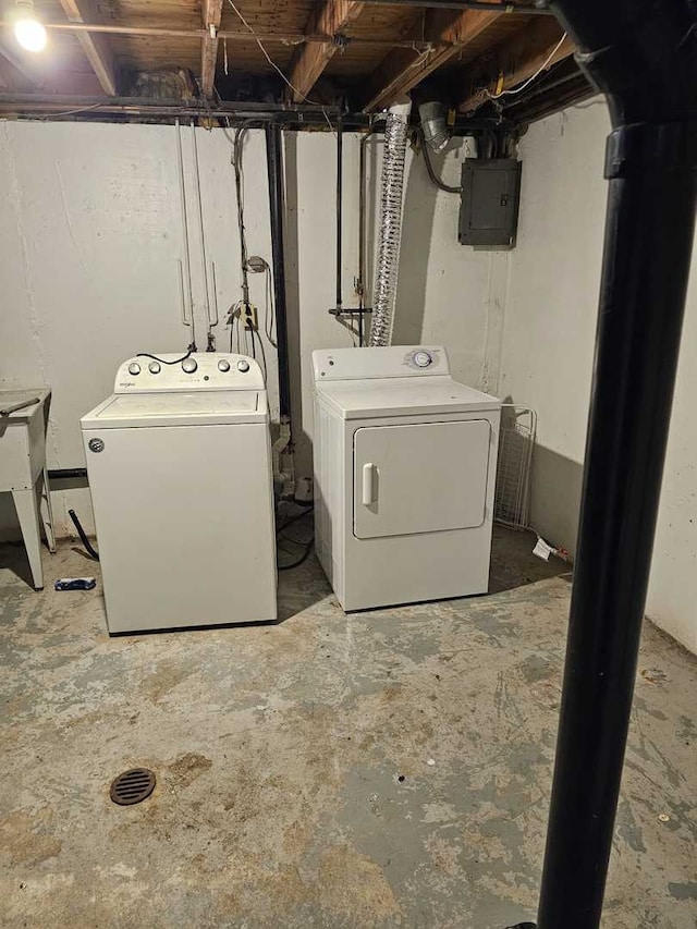 clothes washing area with independent washer and dryer and electric panel