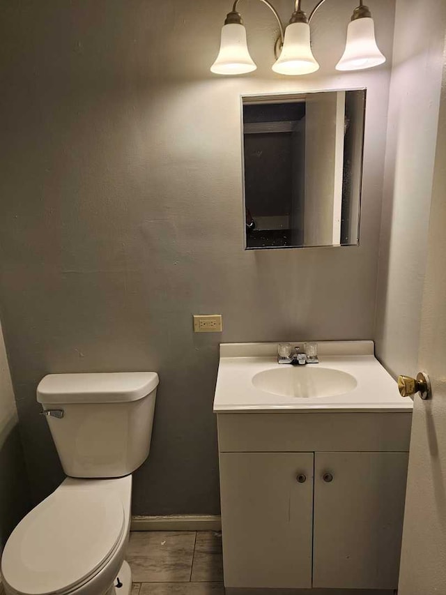 bathroom featuring tile patterned floors, vanity, and toilet