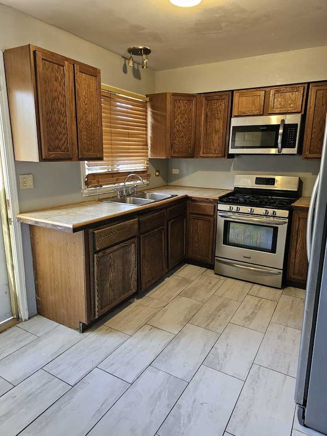 kitchen with sink and appliances with stainless steel finishes