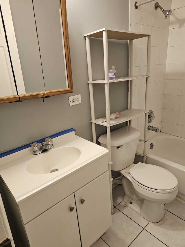 full bathroom featuring tile patterned flooring, vanity, toilet, and tiled shower / bath