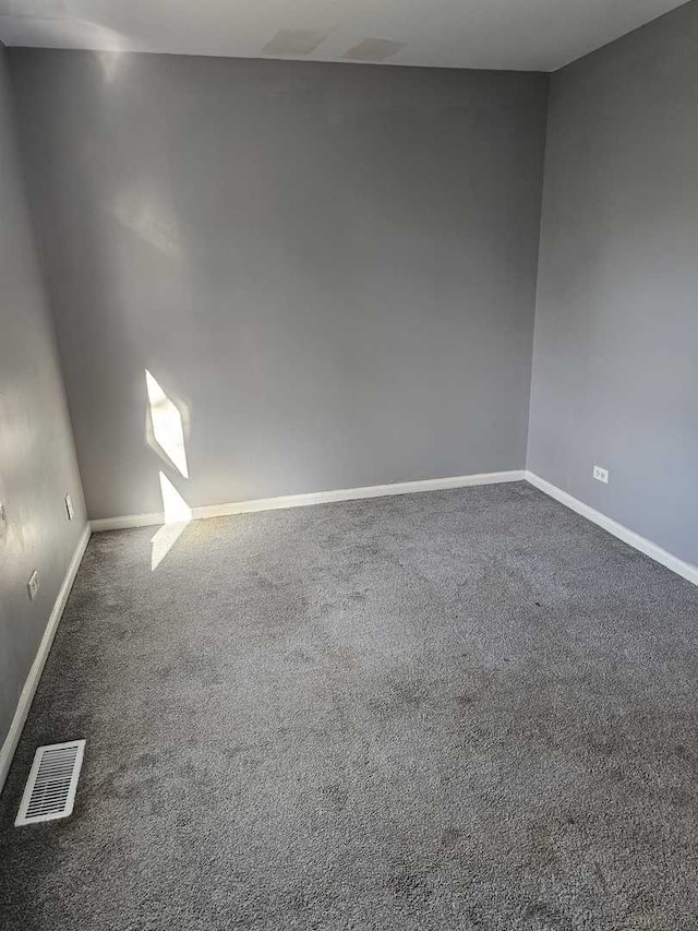 empty room featuring dark colored carpet