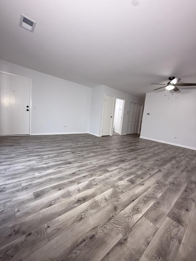 unfurnished living room featuring ceiling fan and wood-type flooring