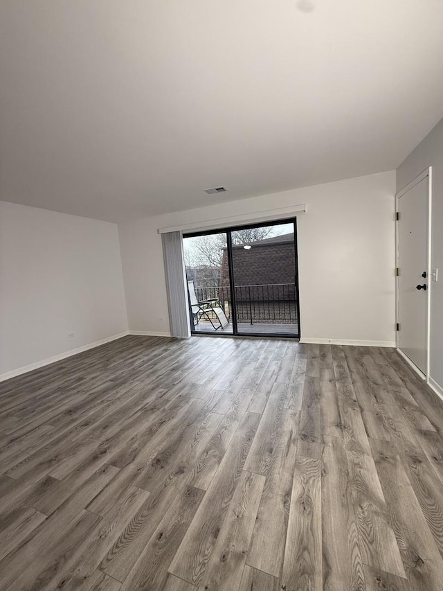 empty room with hardwood / wood-style flooring