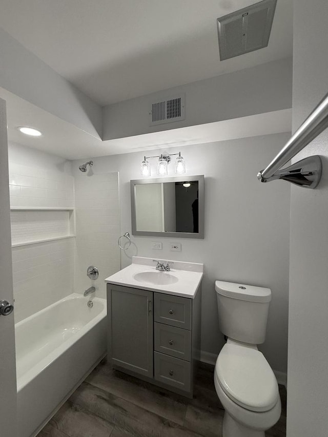 full bathroom featuring hardwood / wood-style floors, vanity, shower / bath combination, and toilet