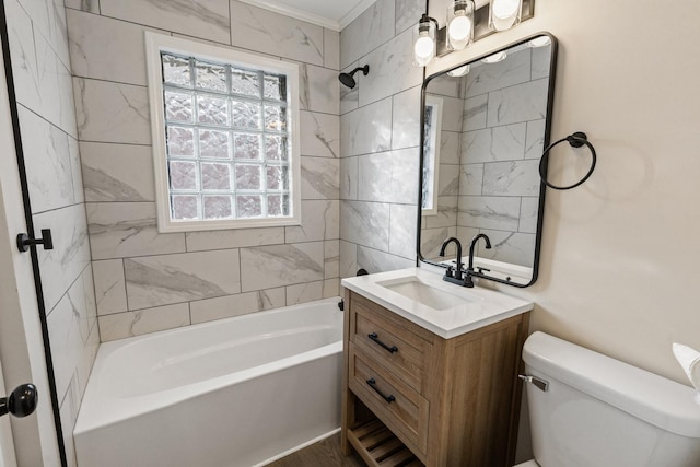 full bathroom with vanity, toilet, ornamental molding, and tiled shower / bath