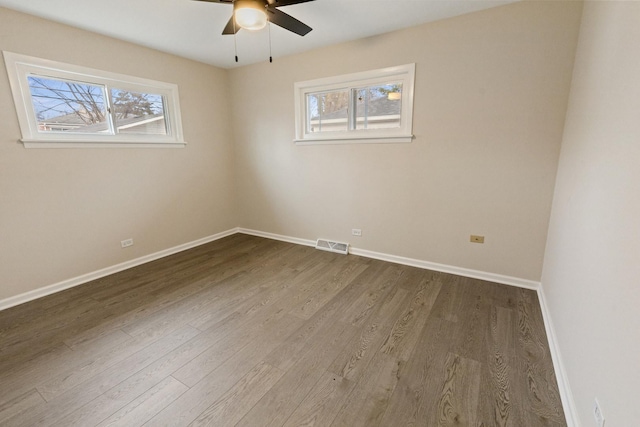 empty room with hardwood / wood-style flooring and ceiling fan