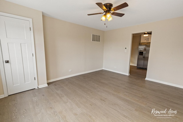 unfurnished room with ceiling fan and wood-type flooring