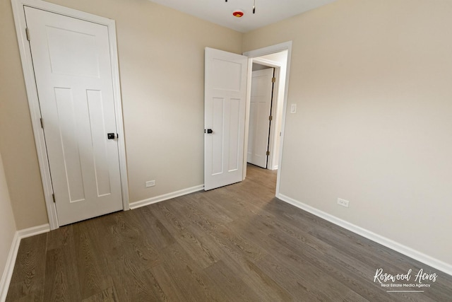 unfurnished bedroom featuring dark wood-type flooring