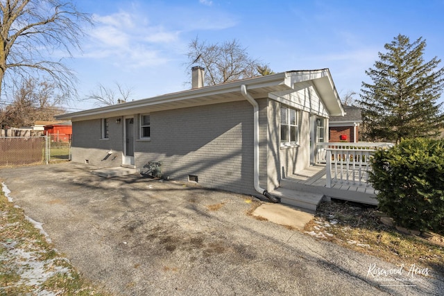 view of side of property featuring a deck