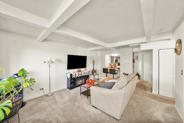 living room featuring beamed ceiling and light colored carpet