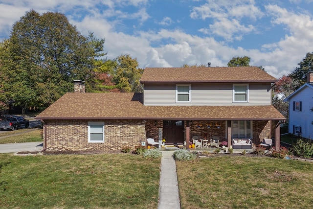 front facade featuring a front yard and a patio area