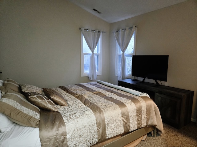 bedroom with carpet and lofted ceiling