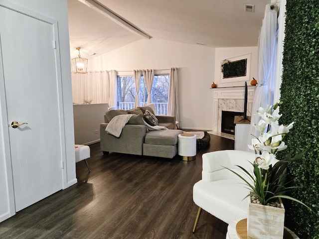 living room featuring a premium fireplace, dark wood-type flooring, and lofted ceiling with beams