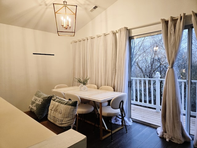 dining area with a chandelier, dark hardwood / wood-style flooring, and vaulted ceiling