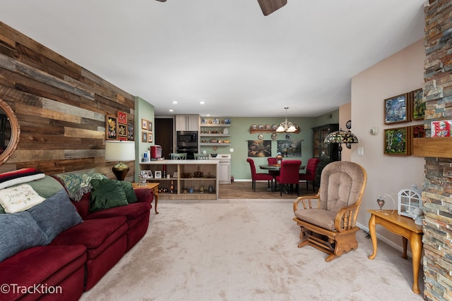 living room with carpet and a notable chandelier