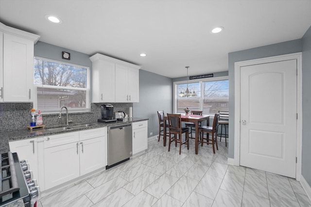 kitchen with dishwasher, sink, tasteful backsplash, white cabinets, and range