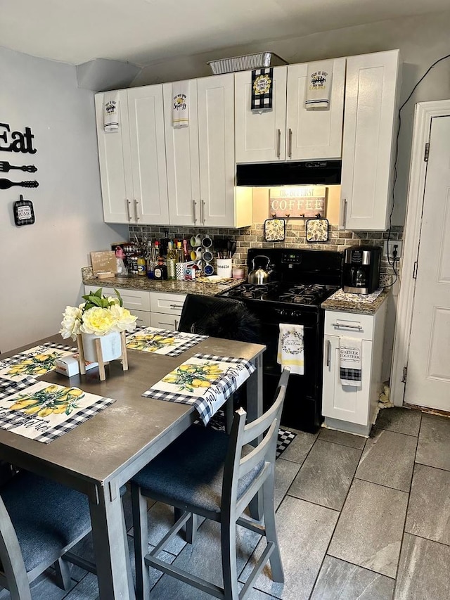 kitchen with decorative backsplash, white cabinetry, stove, and exhaust hood