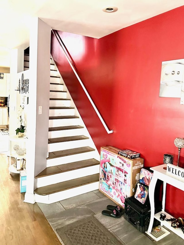 stairway with hardwood / wood-style flooring