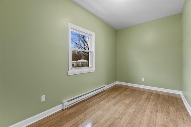 spare room featuring light hardwood / wood-style flooring and a baseboard heating unit