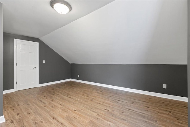 bonus room featuring lofted ceiling and light wood-type flooring