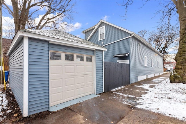 8601 S Houston Ave, Chicago, IL 60617 - view of snow covered exterior featuring an outdoor structure and a garage