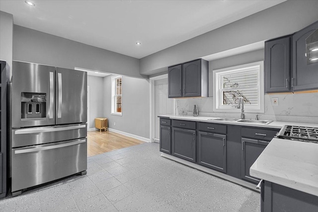 kitchen featuring stainless steel fridge and sink