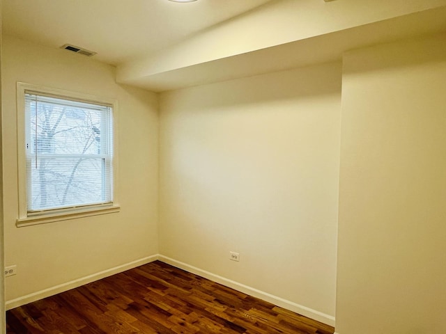 unfurnished room with dark hardwood / wood-style floors