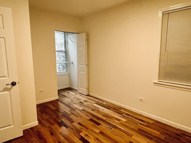 unfurnished bedroom with dark hardwood / wood-style floors