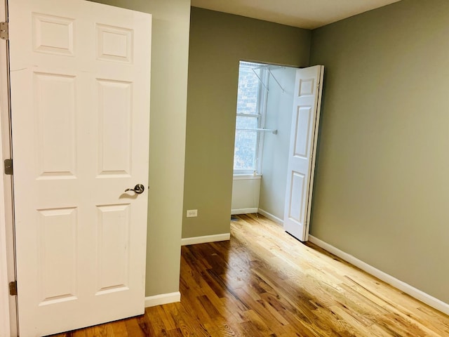 unfurnished room featuring wood-type flooring