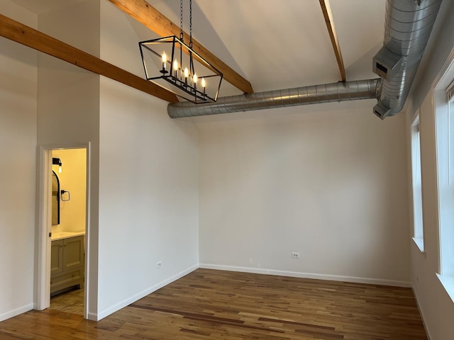 spare room featuring dark hardwood / wood-style floors, beam ceiling, high vaulted ceiling, and a chandelier