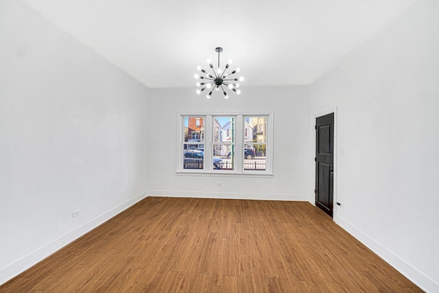 unfurnished dining area with hardwood / wood-style flooring and an inviting chandelier