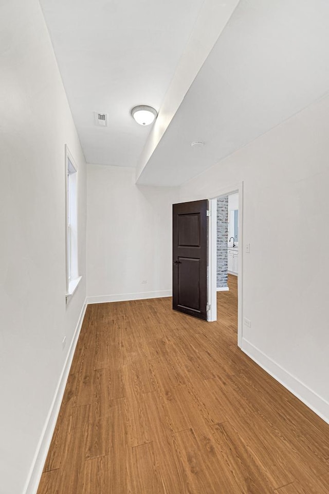 unfurnished room with wood-type flooring