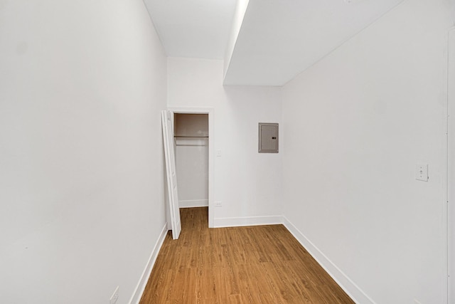 hall with electric panel and light hardwood / wood-style flooring