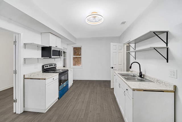 kitchen featuring white cabinetry, sink, dark wood-type flooring, and black range with electric cooktop