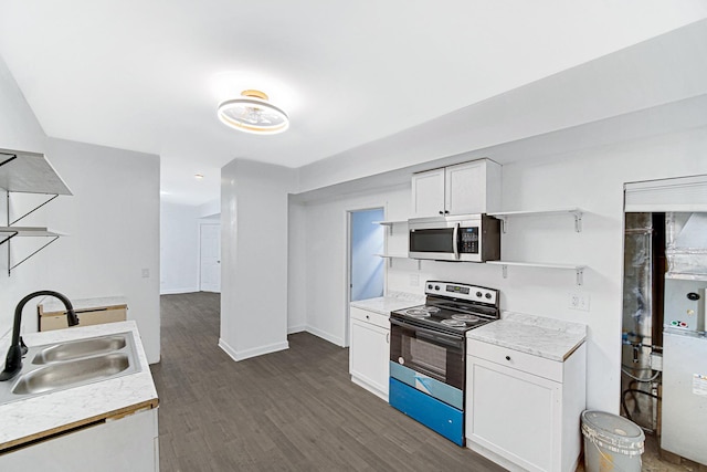 kitchen with sink, white cabinetry, stainless steel appliances, and dark wood-type flooring