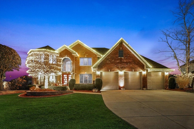 view of front of house with a lawn and a garage