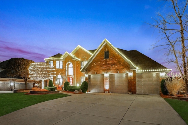 view of front of home with a yard and a garage