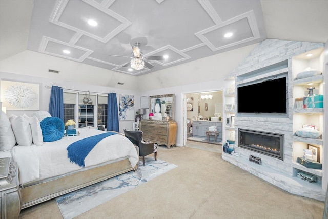 bedroom featuring lofted ceiling, ensuite bathroom, a stone fireplace, ceiling fan, and light colored carpet