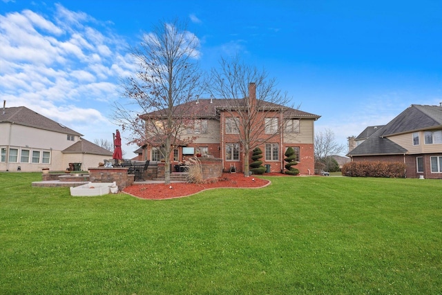 back of property with a patio area and a yard