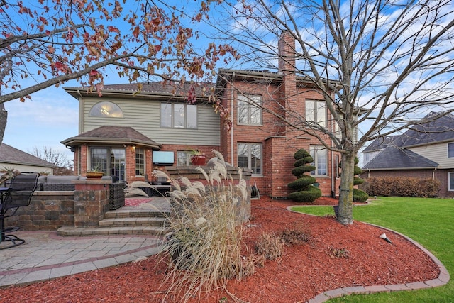 view of front facade with a patio area and a front lawn