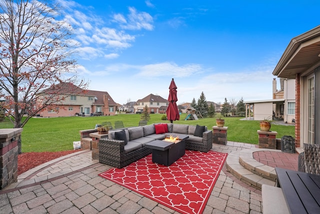 view of patio featuring an outdoor living space with a fire pit