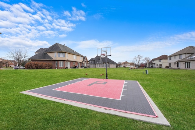 view of sport court featuring a yard